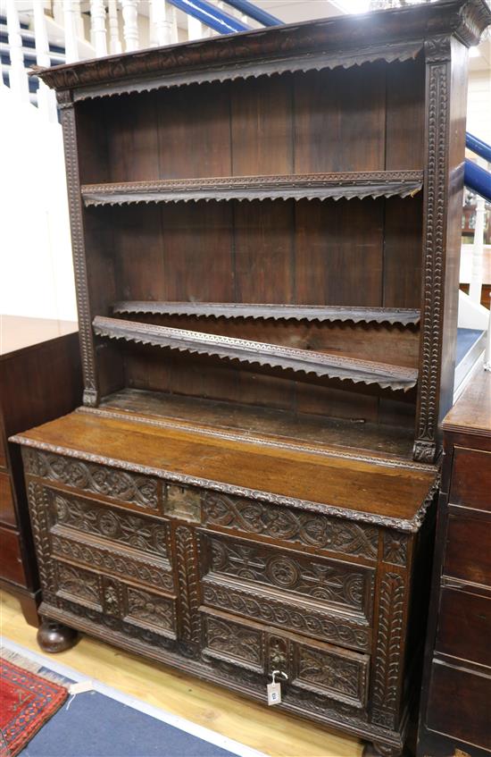 An 18th century oak mule chest, later carved and converted to a dresser W.126cm